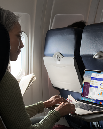 Una persona utiliza un MacBook Air en un avión para demostrar la gran autonomía del dispositivo
