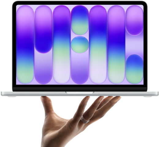 MacBook Neo en plata, portátil sobre las puntas de los dedos de una mano abierta, diseño abstracto a todo color en la pantalla